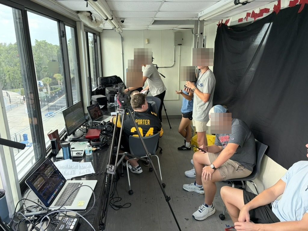 Student crew running a high school football broadcast from the press box